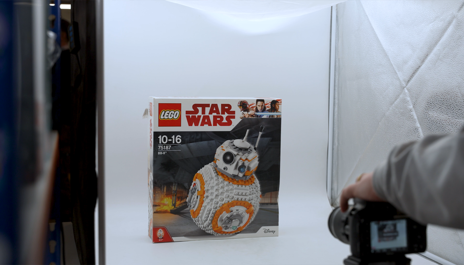 Person taking a picture of a Star Wars™ LEGO® set in a lightbox.png