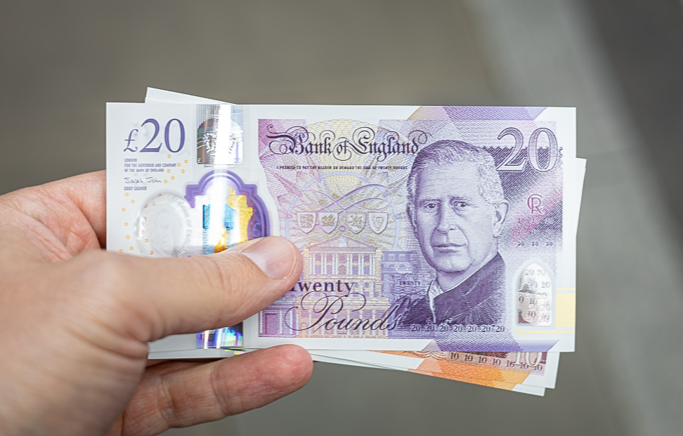 hand hold a collection of £20 notes.png