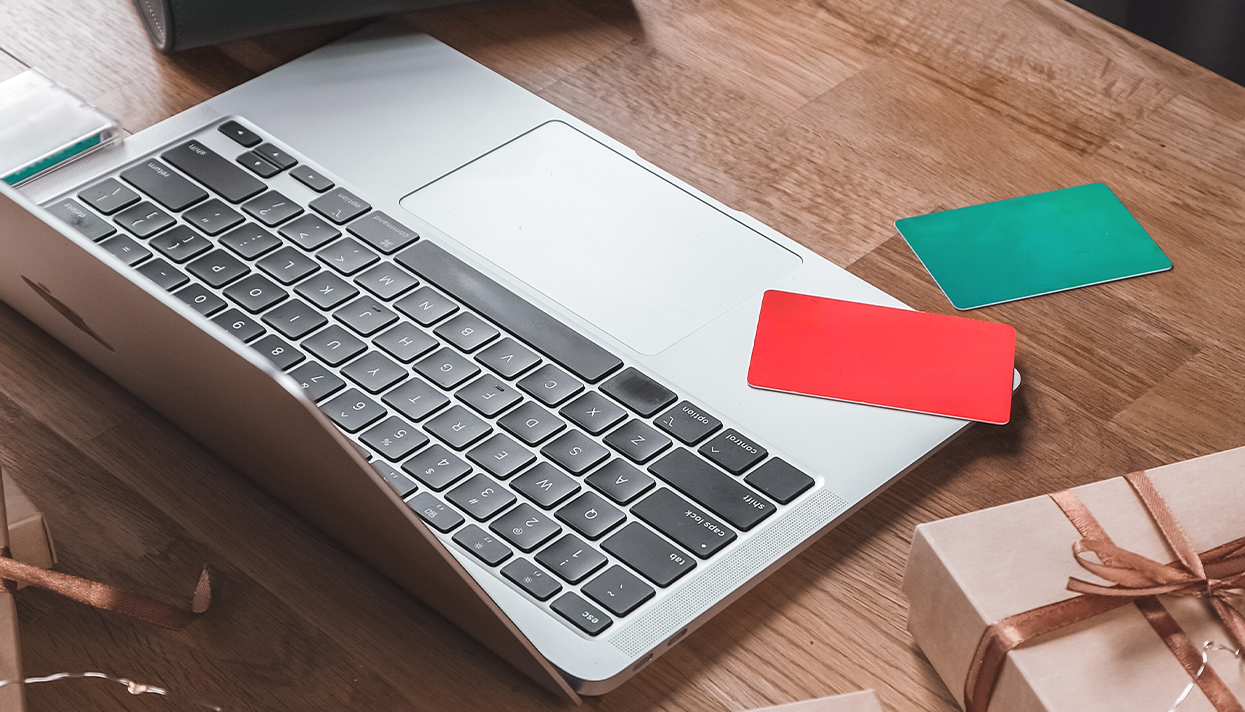 two credit cards on a silver laptop.png