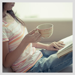 Woman reading with a drink